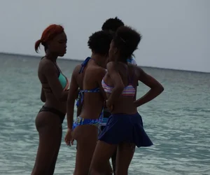 Candid black family, milf and teens on the beach in bikinis