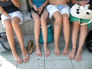 A Group of Young Candid Girls in Shorts Sitting With Bare Feet