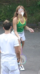 Pretty girl playing tennis in a skirt and walking in jeans