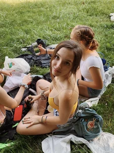 Adorable girl sitting on the grass at a picnic