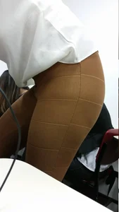 College student girl's thighs in leggings closeup