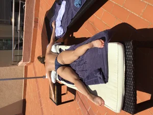 Blonde laying out in a blue bikini with a sexy body