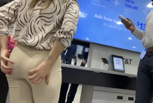 Plus Face shot - Gorgeous AT&T babe in beige pants  touching her ass with long red nails