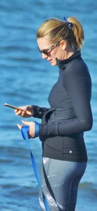 Beach redhead milf in patterened leggings at the beach