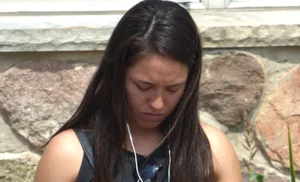 Thick brunette listening to music in shorts