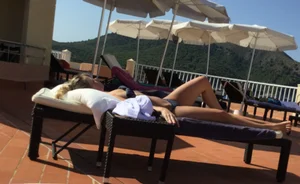Blonde laying out in a blue bikini with a sexy body