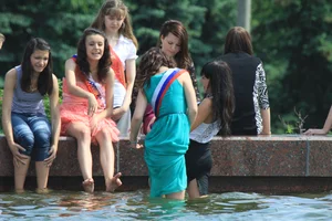 Young College Girls in Dresses, Skirts And Pantyhose Having a Good Time By the City Fountain