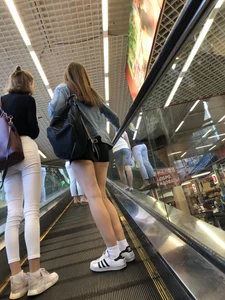 Hot Girls on the Mall Travelator in Mini Shorts and Her Friend in White Pants - Skinny Hot Legs Creepshots