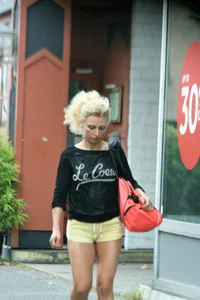 Blonde looking sexy walking in short yellow shorts