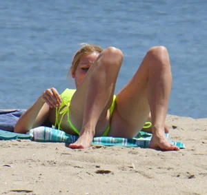 Sexy ass blonde milf on the beach in a thong with cameltoe and bending over
