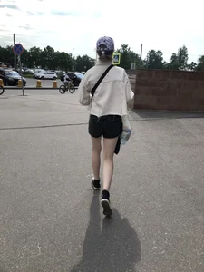Cute candid teen with pale slim legs in shorts