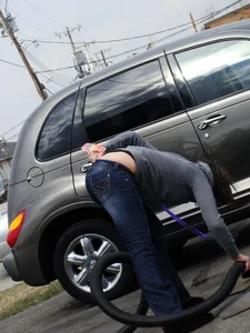 Girl cleaning her car in jeans and showing some cheetah print underwear
