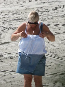 Mature blonde lady on a nude beach with big boobs