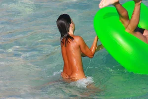 FKK Nudists playing in the water with floater