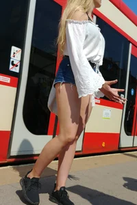 Sexy blonde showing her ass cheeks in short denim shorts and slightly see through shirt