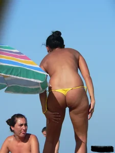 Bunch of sexy babes on the beach topless and in thong bikinis