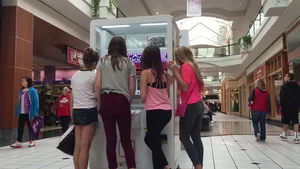 Little blonde teen in grey leggings at the mall with her friends