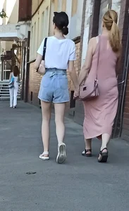 Pale Slim Legs of a Girl in Denim Shorts Street Photo