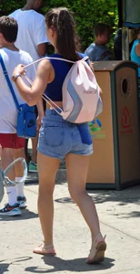 Beautiful girl in a blue top and denim shorts
