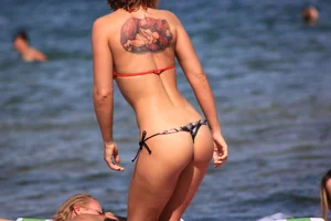 A couple sexy girls laying out on the beach