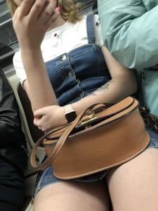 Closeups of a hot candid girl sitting in a subway train