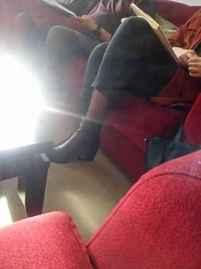 Girl in Pants Reading on the Couch With Crossed Legs - Slim Ankles in Black Pantyhose