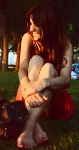 Barefoot Candid Girl Sitting on the Park Lawn