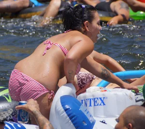 Sexy party girls in bikinis on a lake