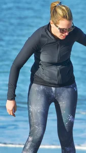 Beach redhead milf in patterened leggings at the beach