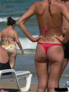 A bunch of hot babes on the beach in thong bikinis