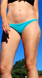 Blonde milf at the pool in small blue bikini