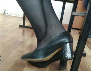 Closeups of college girls' legs and feet in pantyhose and various shoes (including high heels) in classrooms
