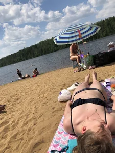Cute Candid Girl Lying on Sand by the Lake