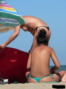 Bunch of sexy babes on the beach topless and in thong bikinis