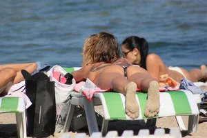 A couple sexy girls laying out on the beach