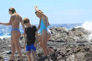 Group of sexy teens in thong swimsuits and bikinis at the beach