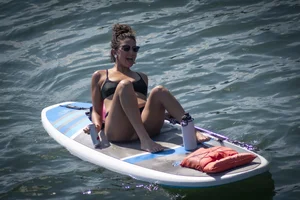 Brunette in thong bikini shows ass, crotch, boobs, and feet
