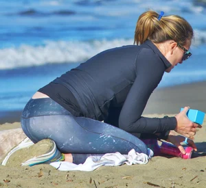 Beach redhead milf in patterened leggings at the beach