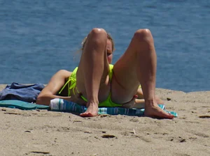 Sexy ass blonde milf on the beach in a thong with cameltoe and bending over
