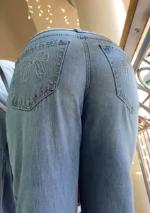 Booty in Bow Bottom Blue Jeans Bends Over, Closeup From Below