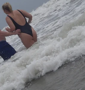 Thick blonde on the beach with a big booty in a blue swimsuit