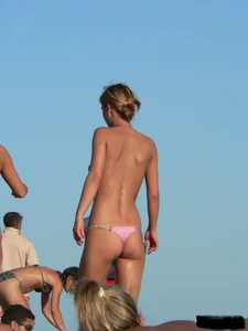 Bunch of sexy babes on the beach topless and in thong bikinis