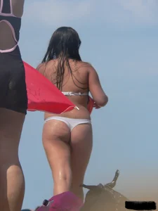Couple of thick beach teens in little thong bikinis