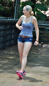 Cute blonde in denim shorts and a wet top
