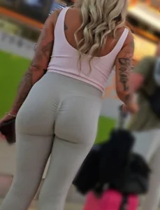 Fit blonde in grey leggings with a Fat Ass