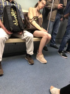 Very Skinny Girl Wearing Glasses with Long Legs in a Short Skirt Falling Asleep in a Subway Train Candid