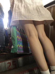 Cute Girl in a Dress with Thin Hot Legs Standing on the Subway Escalator Closeup Creepshots Gallery
