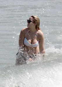 Big boobed thick blonde on the beach in a bikini