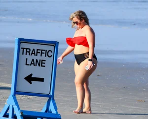 Thick BBW blonde lady in a bikini at the beach