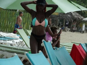 Candid black family, milf and teens on the beach in bikinis